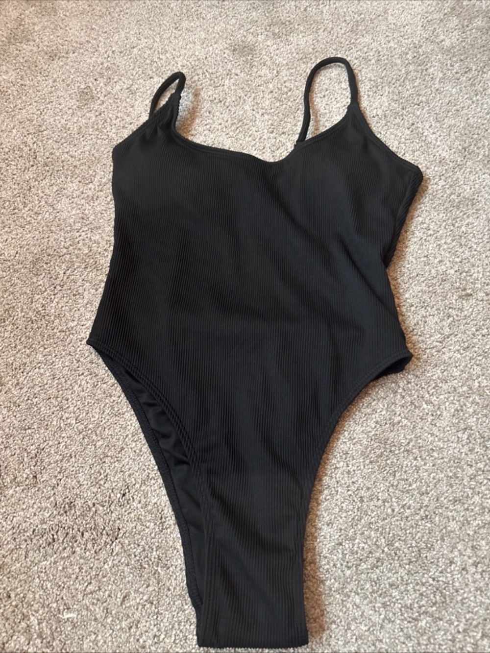 Black Ribbed One-Piece Swimsuit. Adjustable straps. New without tags.